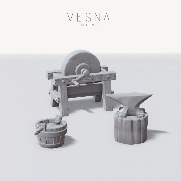 Blacksmith anvil and grindstone